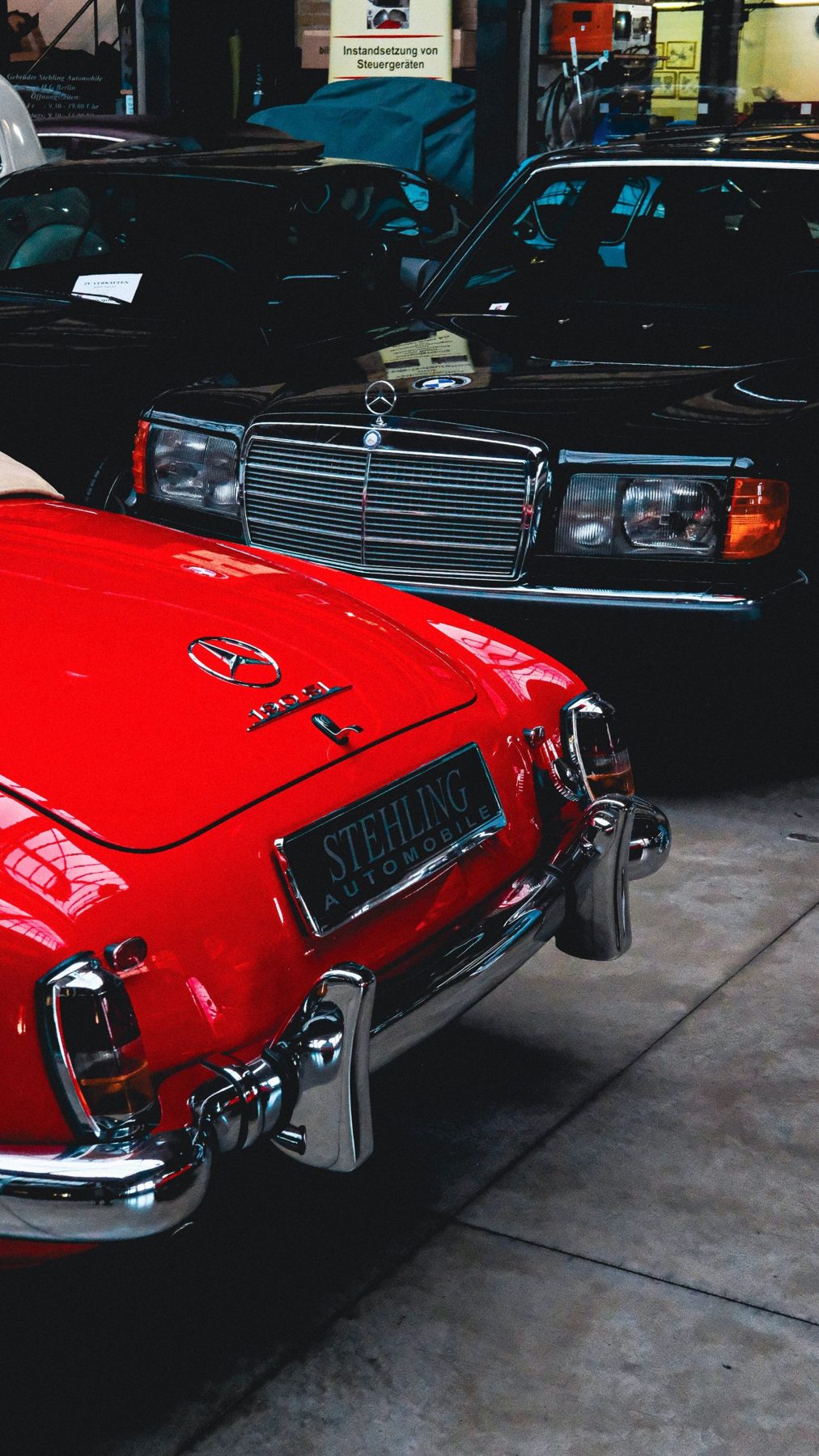 Classic cars lined up in a dealer showroom