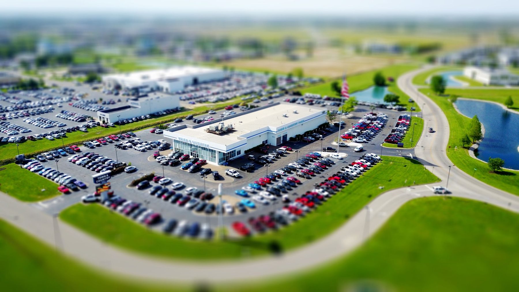 Aerial view of a car dealership with a full lot of vehicles